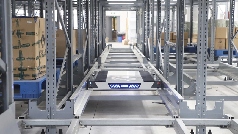Four-way shuttle moving pallets inside high-density racking system