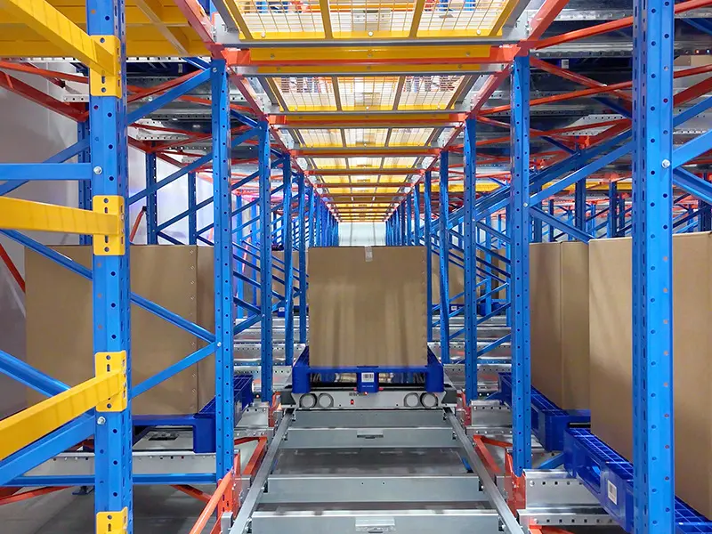 Four-way shuttle moving pallets inside high-density racking system