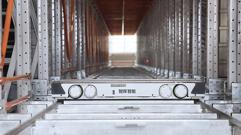 Four-way shuttle moving pallets inside high-density racking system
