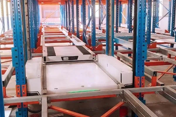 a modern automated warehouse interior featuring a high bay asrs (automated storage and retrieval system) with pallet racking, four way shuttle systems, vertical lifts, and conveyor interfaces.